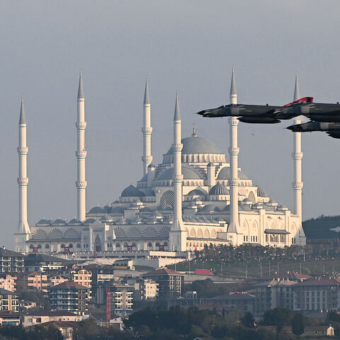 Turkish air force fighter jets perform a military parade over the Bosphorus as Camlica mosque is seen in the background to mark the 100th anniversary of Turkish Republic in Istanbul on Oct. 29, 2023. 